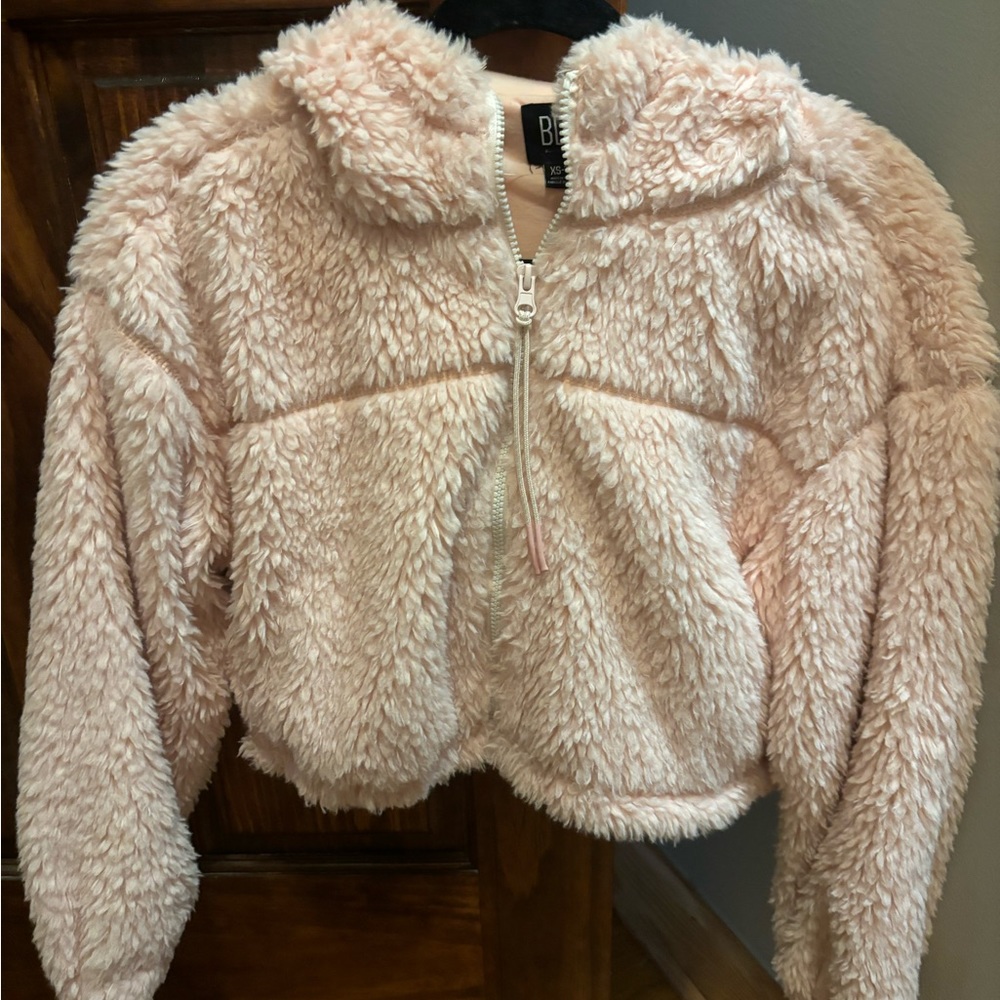 Cropped pink fluffy jacket from Urban Outfitters